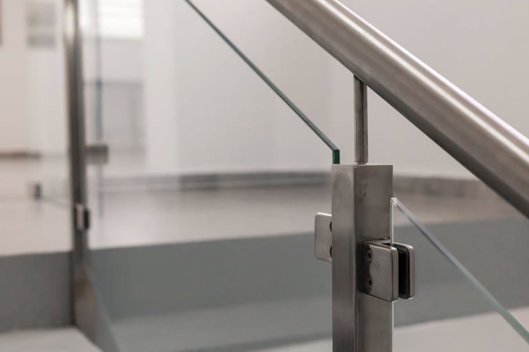 Close-up view of a sleek metal and glass railing, showcasing modern architectural details