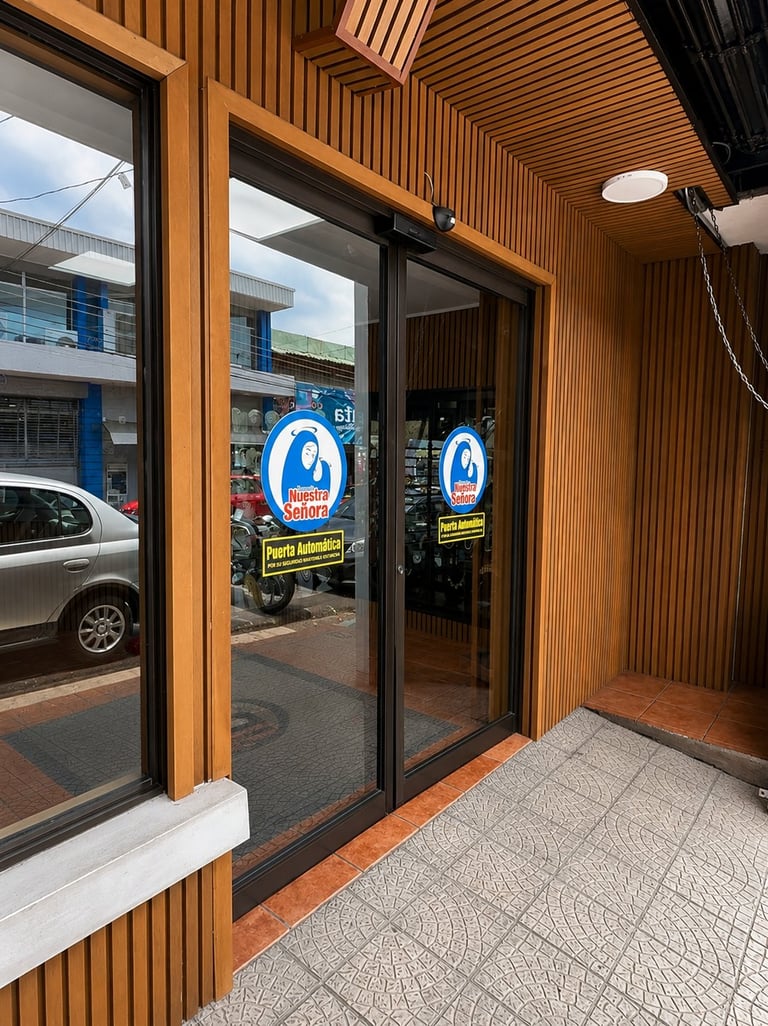 Storefront entrance with wooden framing, glass doors, and blue oval logo signage, modern commercial building exterior
